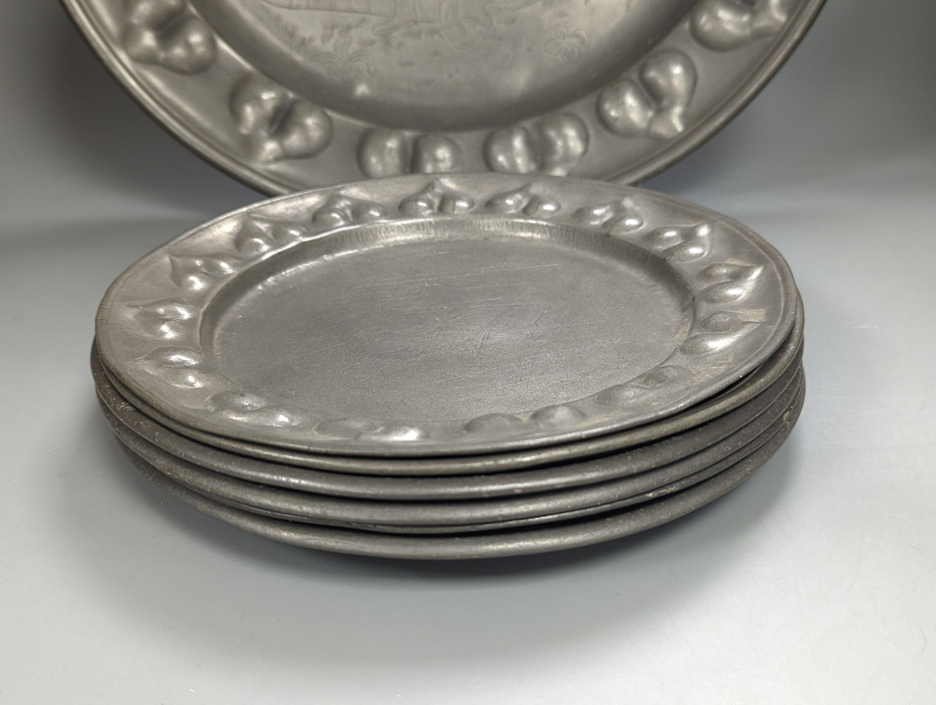 A near pair of Salzburg pewter wrigglework chargers, diameter 41cm, and six similar plates, 18th/19th century